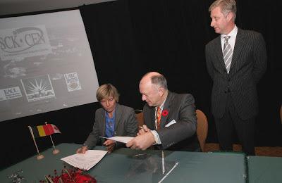 Photos of Director of SCK-CEN, Pr. Frank De Coninck (seated) and Dr. Dominique Weis signing a Memorandum of Understanding between UBC and the Belgian Nuclear Research Centre, as Prince Philippe of Belgium looks on