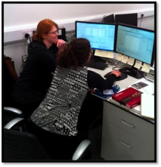 Photo of Genna and Anais analyzing data at the Nu Instruments factory